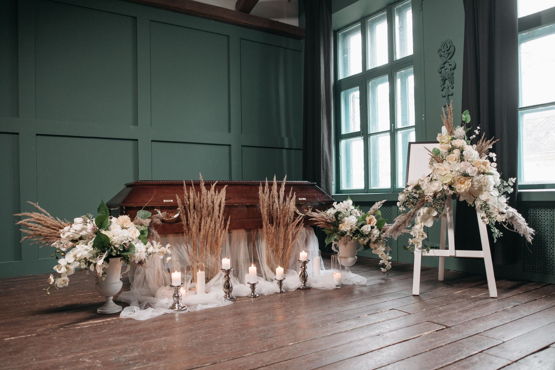 A peaceful funeral chapel with casket, flowers, and candles beautifully arranged